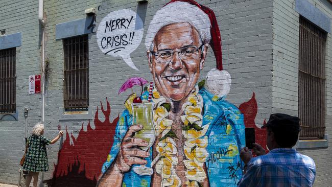 Just one of the critical responses directed at Scott Morrison for his ill-fated family holiday to Hawaii. The mural is by artist Scott Marsh. Picture: Jenny Evans/Getty Images.