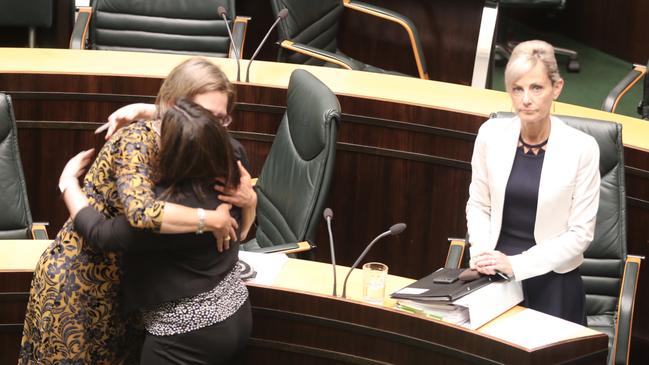 Greens leader Cassy O'Connor and Labor's Ella Haddad celebrate in State Parliament as Attorney General Elise Archer stands after the passage new legislation about birth certificates on Tuesday, November 20, 2018.