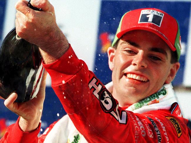 Racing driver Craig Lowndes pouring champagne celebrating win.Motor car racing - Sensational Adelaide 500 V8 Supercars race 11 Apr 1999.