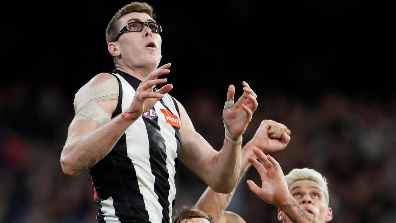 Mason Cox climbs for a big mark over Sean Darcy and Rory Lobb. Picture: Dylan Burns/AFL Photos via Getty Images