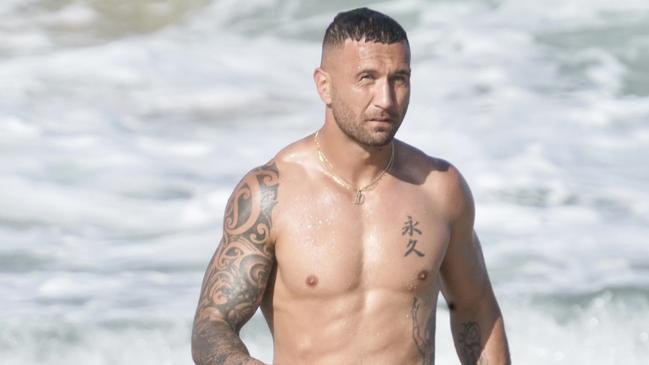 Wallaby hero Quade Cooper takes a dip at Broadbeach.