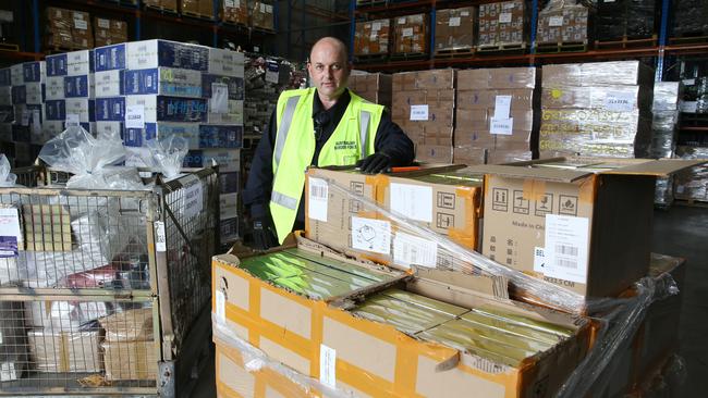 Border Force officer Antony Wigoder with detained vapes at Port Botany in Sydney, awaiting TGA approval to be destroyed. Picture: Britta Campion