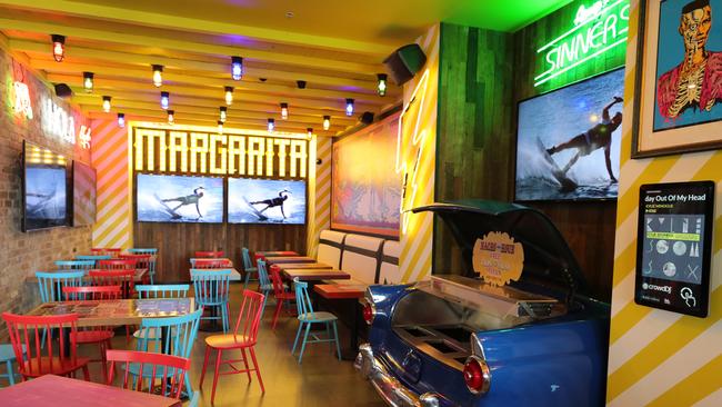 The fit-out with neon bright lights, colourful murals, cactuses, hubcaps and skulls turns heads. Picture: Glenn Hampson