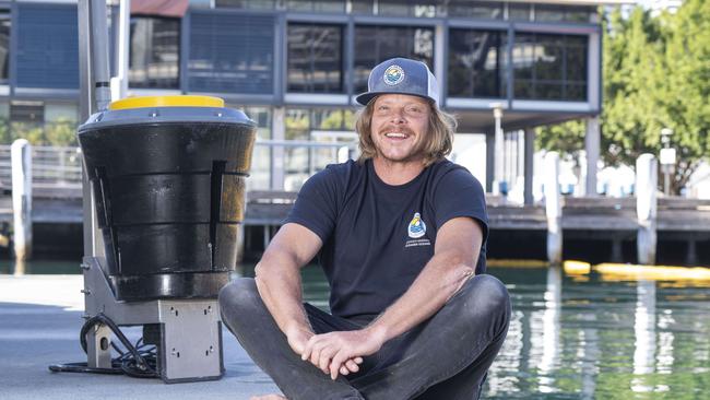 Seabin chief executive and co-founder Pete Ceglinski with a bin installed at Pyrmont. Picture: AAP/Image Matthew Vasilescu