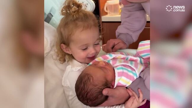 Travis Head's daughter holds new baby brother for the first time