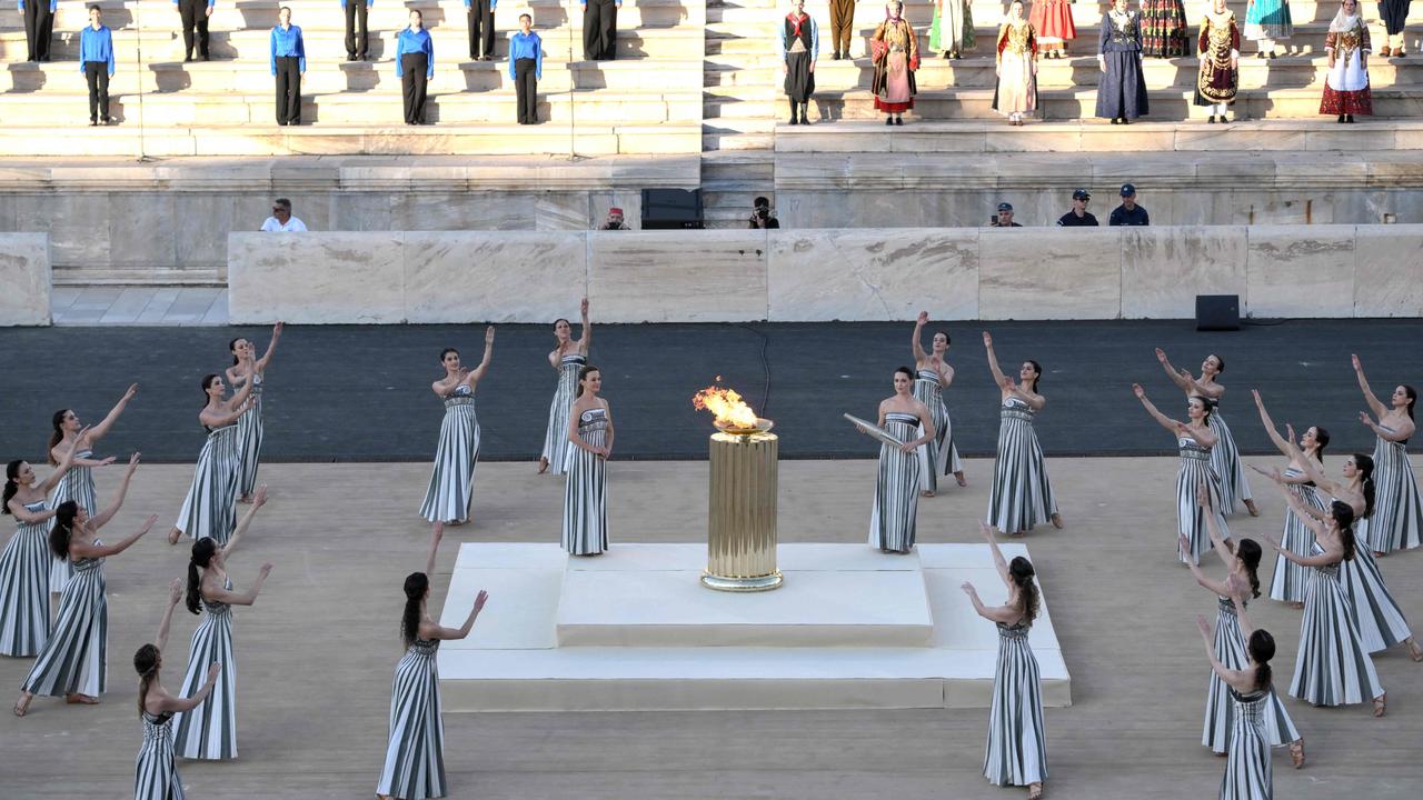 Priestesses perform a dance during the handover ceremony of the Olympic Flame for the Paris 2024 Summer Games at the Panathinean stadium in Athens. Picture: Angelos Tzortzinis / AFP