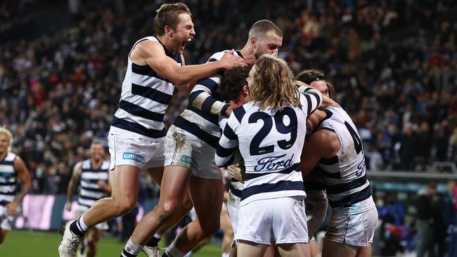 Cats players mob Gary Rohan after he kicked a goal after the siren to seal the game on Friday night. Picture: Michael Klein