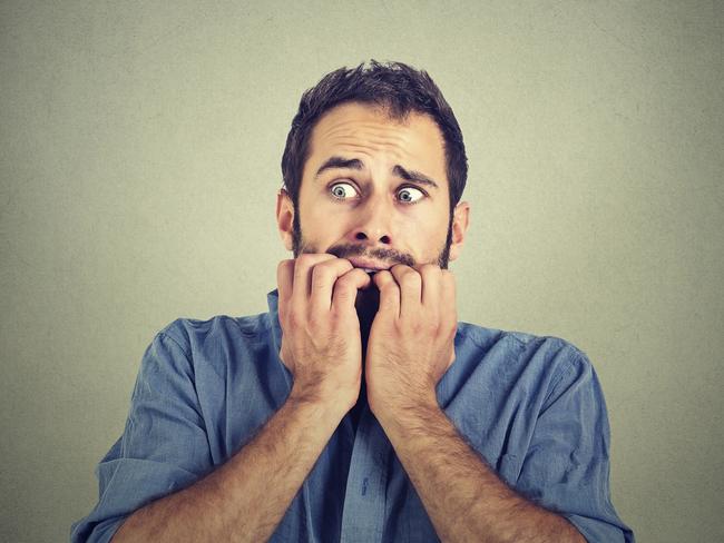 Portrait anxious young man biting his nails fingers freaking out, frightened, generic, scared