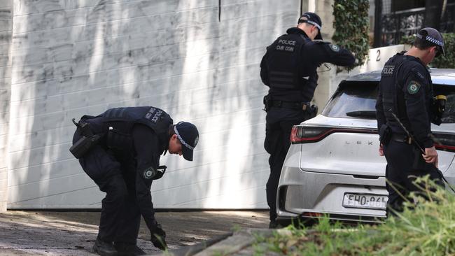 Officers at the scene of a firebombing and vandalism in Magney Street Woollahra in December. Picture: Rohan Kelly