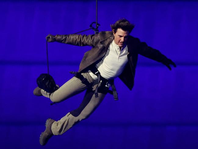 US' actor Tom Cruise jumps from the roof of the Stade de France during the closing ceremony of the Paris 2024 Olympic Games at the Stade de France, in Saint-Denis, in the outskirts of Paris, on August 11, 2024. (Photo by Phil Noble / POOL / AFP)