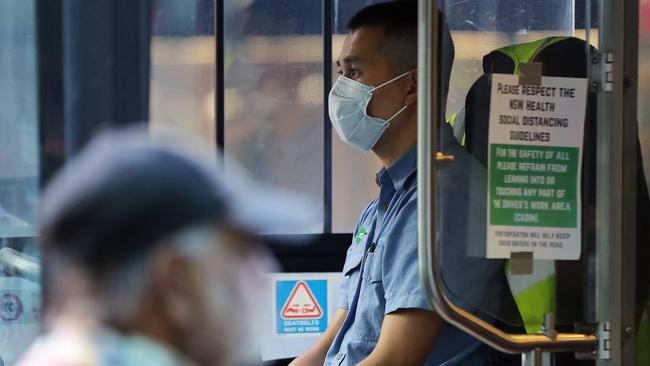 A bus driver wears a mask as a preventative measure against the coronavirus disease at Railway Square bus station in Sydney. Picture: Steven Saphore.