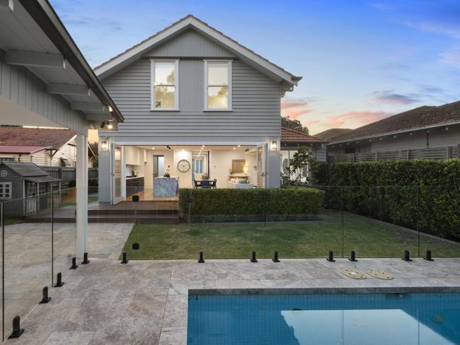 The back yard features a solar-heated swimming pool, cubby house and putting green.