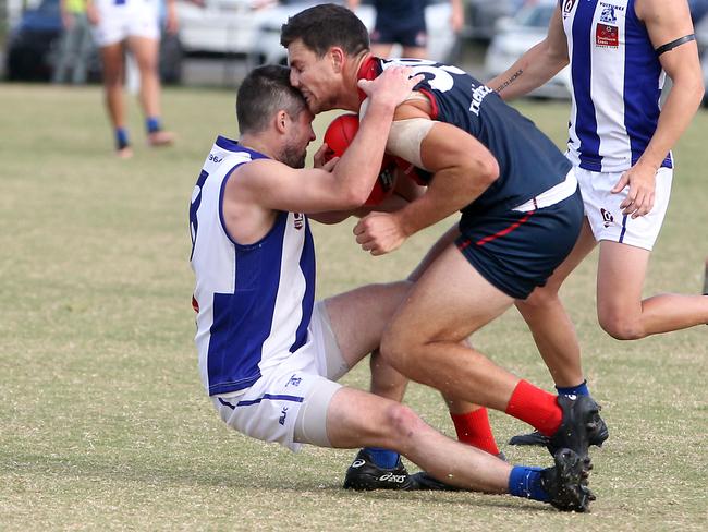 Round 9 of the QAFL Australian rules competition. Surfers Paradise (Demons) v Mt Gravatt at Sir Bruce Small Park. Photo of Jack Yelland tackled. Photo by Richard Gosling