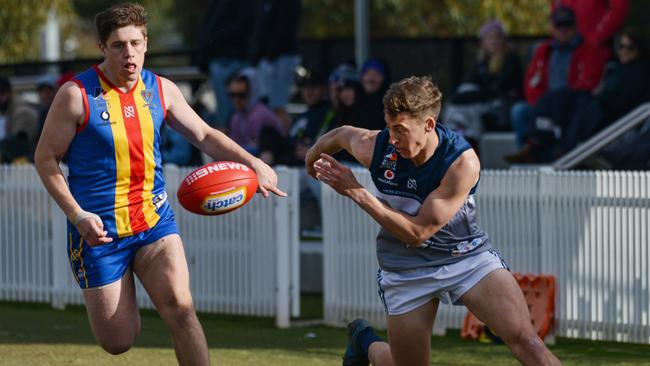 Henley’s player Liam Martin tries to keep the ball in ahead of Old Ignatians’ Jack Armfield. Picture: Brenton Edwards