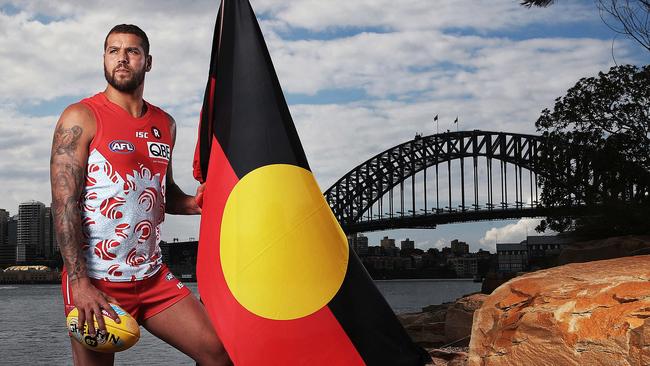 Lance 'Buddy' Franklin at Barangaroo in Sydney with the Aboriginal flag ahead of this week’s AFL Indigenous Round. Picture. Phil Hillyard