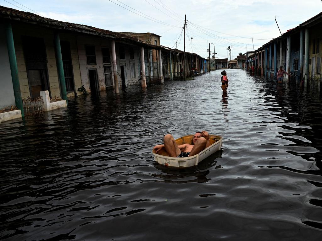 A man rides a handmade raft through a flooded street following the passage of Hurricane Helene in Batabano, Mayabeque province, Cuba, on September 26, 2024. Picture: AFP