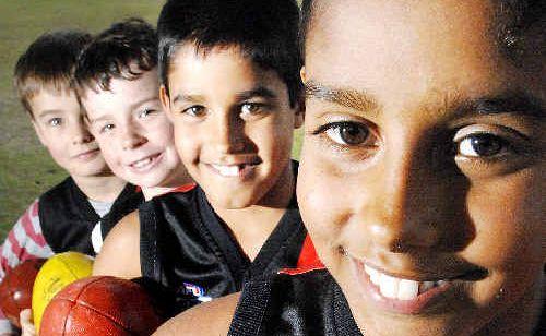 Some of the Ballina Bomber’s youngest AFL players (from front) Jeremy Jago, 10, Patrick Jago, 9, Will Bainbridge, 8, and Ned Bainbridge, 6, are happy they’ll soon be able to play under proper lighting at Fripp Oval in Ballina. Picture: Jay Cronan