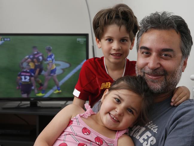 Basak Yagci (ok) watching the NRL in his London home with son Kaya, 6, (red shirt), and daughter Lara, 5, (pink dress). The game was played on Sky Sports main channel.,  Picture Hollie Adams