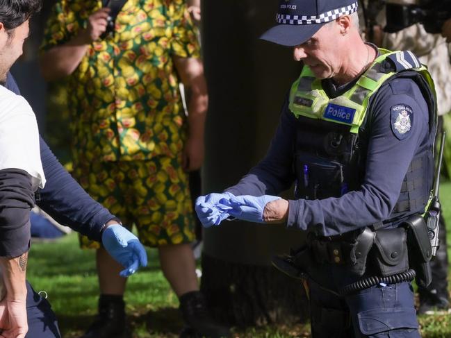 MELBOURNE, AUSTRALIA - NCA NewsWire Photos APRIL 20, 2024 :  420 picnic at Flagstaff Gardens promoting the legalisation of cannabis.Police do a body search on a man.  Picture: NCA NewsWire / Ian Currie