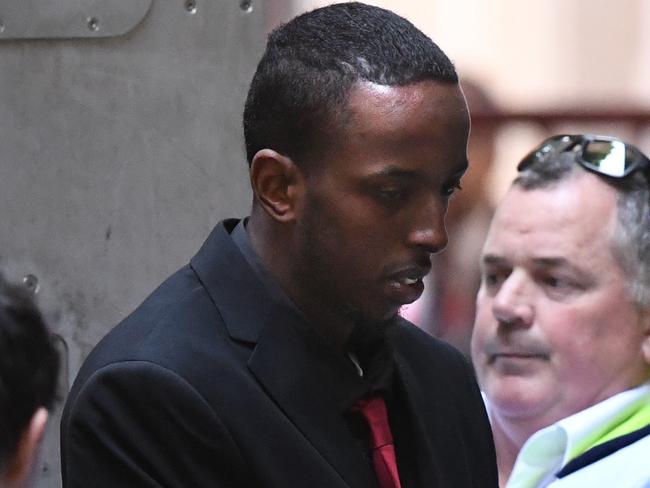 Ali Khalif Shire Ali (second from left) arrives at the Supreme Court of Victoria in Melbourne, Thursday, November 28, 2019. The 22-year-old admitted to plotting a New Year's Eve terrorist attack on Federation Square. (AAP Image/Julian Smith) NO ARCHIVING