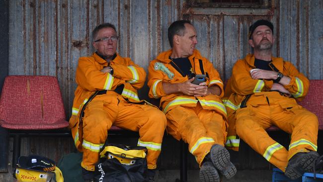 CFS firefighters at Kingscote Oval, after fighting fires throughout the night earlier this week. Picture: AAP / David Mariuz