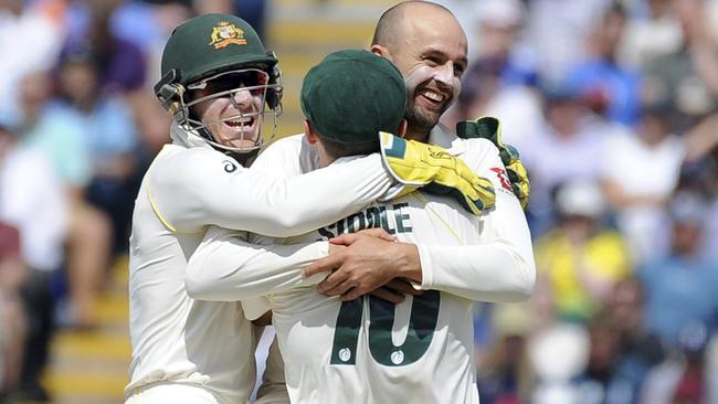 Australia's Nathan Lyon, right, with team-mates on the way to a six-wicket haul. Picture: AP