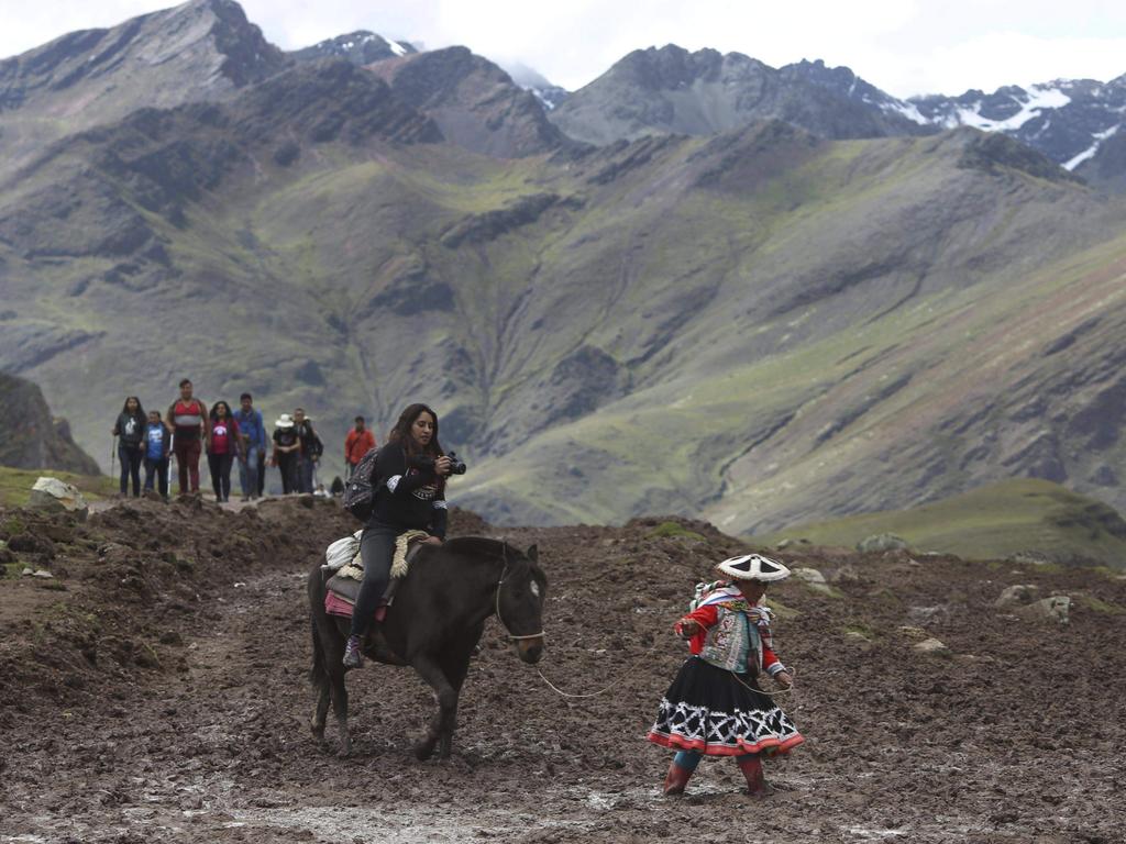 Tourists are led up the mountain by guides. Picture: AP/Martin Mejia