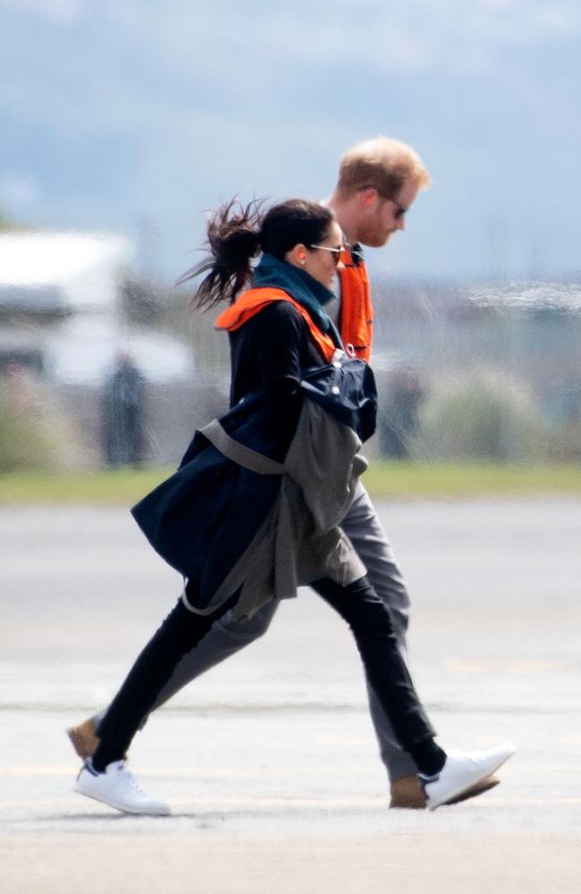 Britan's Prince Harry and his wife Meghan, the Duchess of Sussex, arrive at the military terminal to board an Air Force NH90 helicopter. Picture: AFP