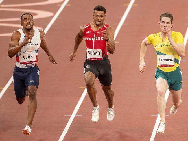 TOKYO, JAPAN - JULY 31: Rohan Browning of Australia winning heat seven of the 100m preliminary round for men from Chijindu Utah of Great Britain and Kojo Musah of Denmark during the Athletics competition at the Olympic Stadium at the Tokyo 2020 Summer Olympic Games on July 31, 2021 in Tokyo, Japan. (Photo by Tim Clayton/Corbis via Getty Images)