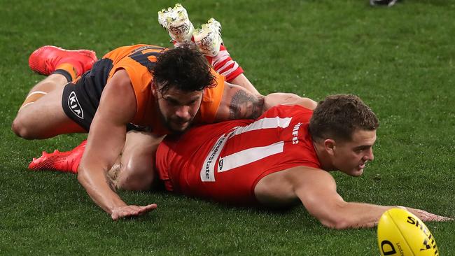 Giant Zac Williams tackles Swan Tom Papley during Thursday night’s game. Picture: Paul Kane/Getty Images