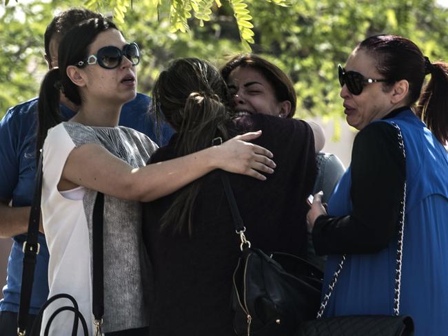 Families of passengers who were flying in an EgyptAir plane that vanished from radar en route from Paris to Cairo react as they wait outside a services hall at Cairo airport on May 19. Picture: AFP/Khaled Desouki