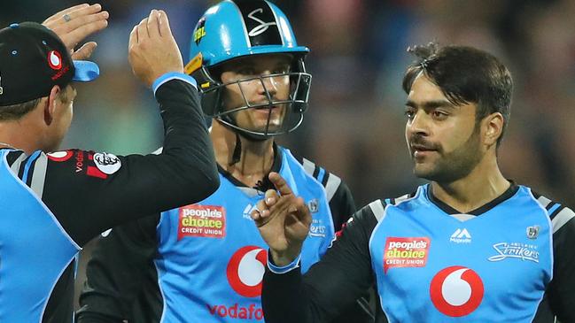 Adelaide Strikers Rashid Khan of the Strikers is congratulated by Colin Ingram and Alex Carey after dismissing Melbourne Renegades’ batsman Cameron White at GMHBA Stadium. Picture: Photo by Scott Barbour/Getty Images.