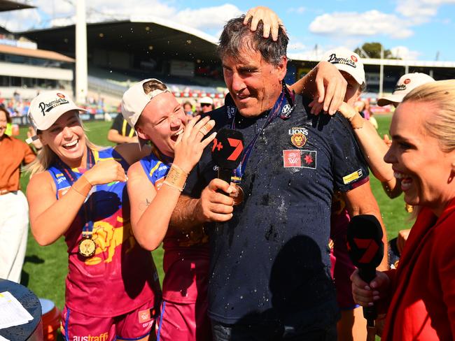 Coach Craig Starcevich is drenched after Brisbane’s premiership win.