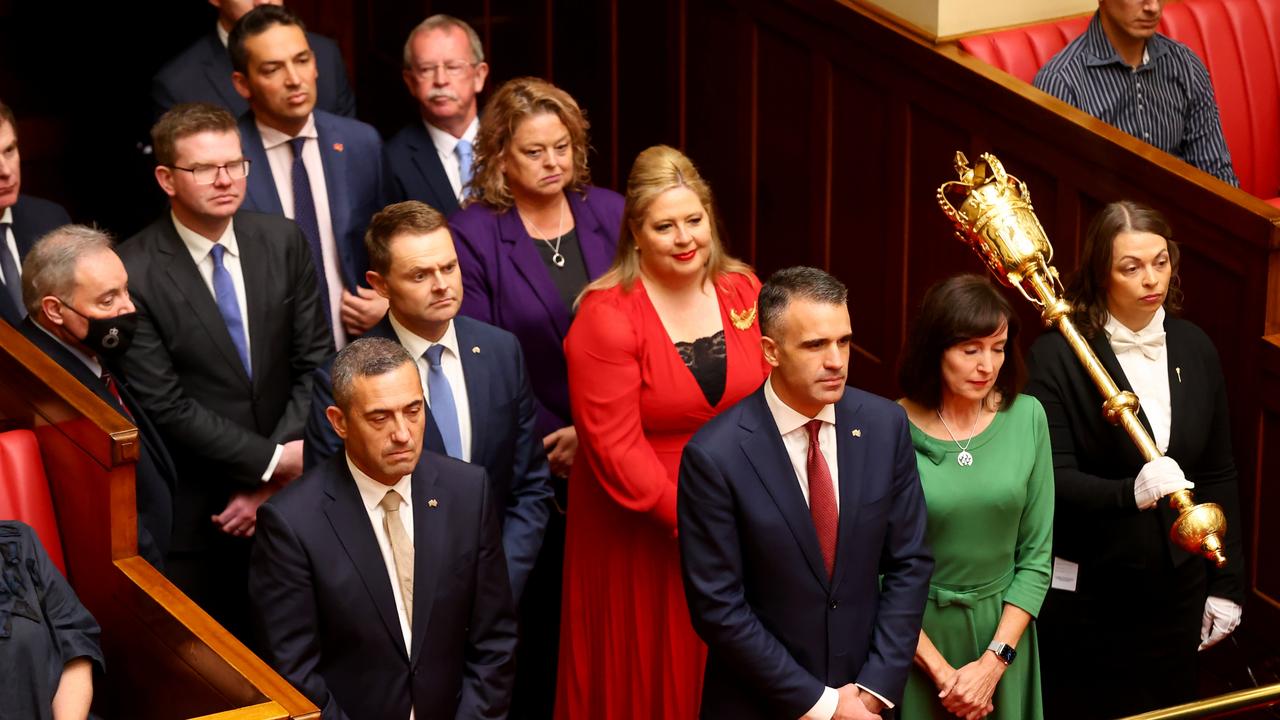 Labor MPs wait to enter parliament on the first day of their new government – but just one mask in sight. Picture: NCA NewsWire / Kelly Barnes