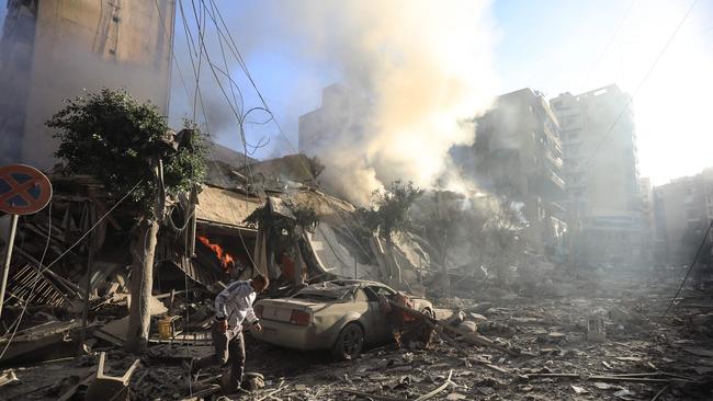 A man walks amid the rubble of a building hit in an overnight Israeli air strike that targeted the neighbourhood of Moawwad in Beirut's southern suburbs on October 3, 2024. Picture: AFP