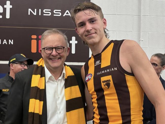 Anthony Albanese with Calsher Dear in the Hawks rooms after the win on Friday night.