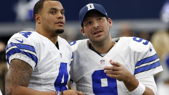 Dallas Cowboys' Dak Prescott (4) and Tony Romo (9) talk on the sideline.