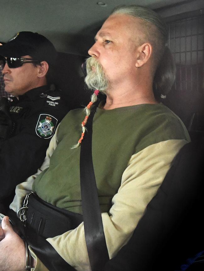 A man under arrest is driven by police to the Police Watch House in Brisbane, Wednesday, August 22, 2018. (AAP Image/Dave Hunt)