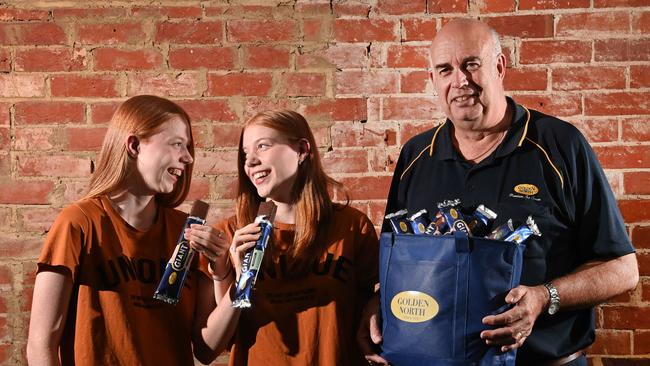 Twins Tamika and Jasmine Coveney with Golden North marketing and exports director Trevor Pomery. Picture: Keryn Stevens.