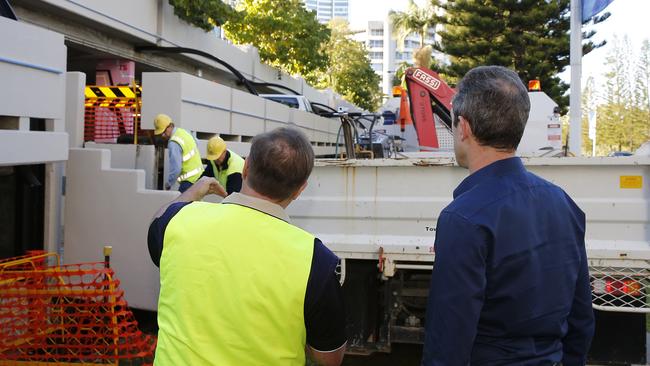 Gold Coast City Council workers moving a piece of concrete that fell and injured a women on Wednesday night at the Bruce Bishop Carpark. Council's CEO Dale Dickson (right). Photo: Jerad Williams