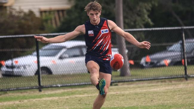 Simon Hawkins gets a kick away for Waverley Blues. Picture: Davis Harrigan