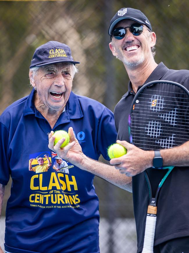 Henry Young, 99, on court with tennis coach Darren Cahill at the Adelaide International event. Picture: Tom Huntley