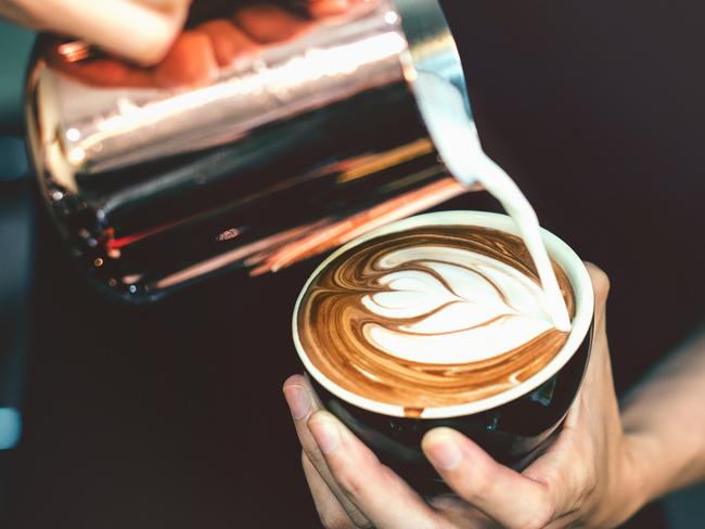 How to make latte art by barista focus in milk and coffee in vintage color tone.