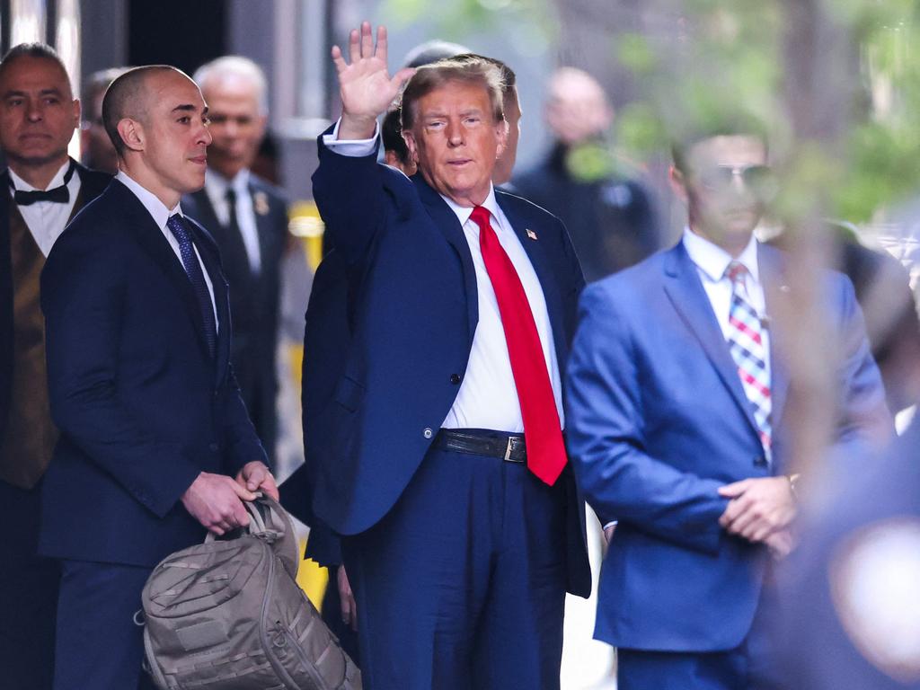 TDonald Trump waves as he departs Trump Tower for Manhattan Criminal Court. Picture: AFP