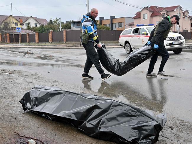 Communal workers carry body bags following Russian shelling of the town of Bucha. Russia was suspended from the UN Human Rights Council. Picture: AFP