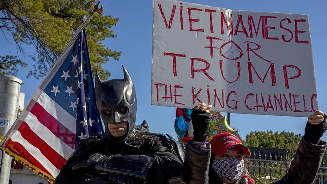 A man dressed as batman stands beside Trump supporters outside the Walter Reed National Military Medical Center. Picture: AFP