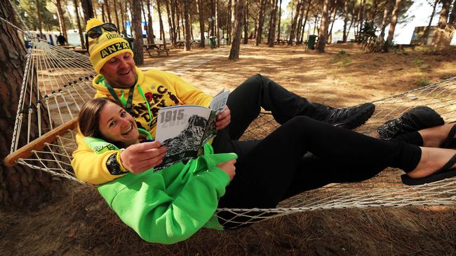 The first busload of Australians arrive at the holding beach, Mimosa, before they move to the Australian Commemorative Site about 6pm. Terry Howe and Kristie Young grab a hammock and catch-up on some reading on Gallipoli. Picture: Sam Ruttyn