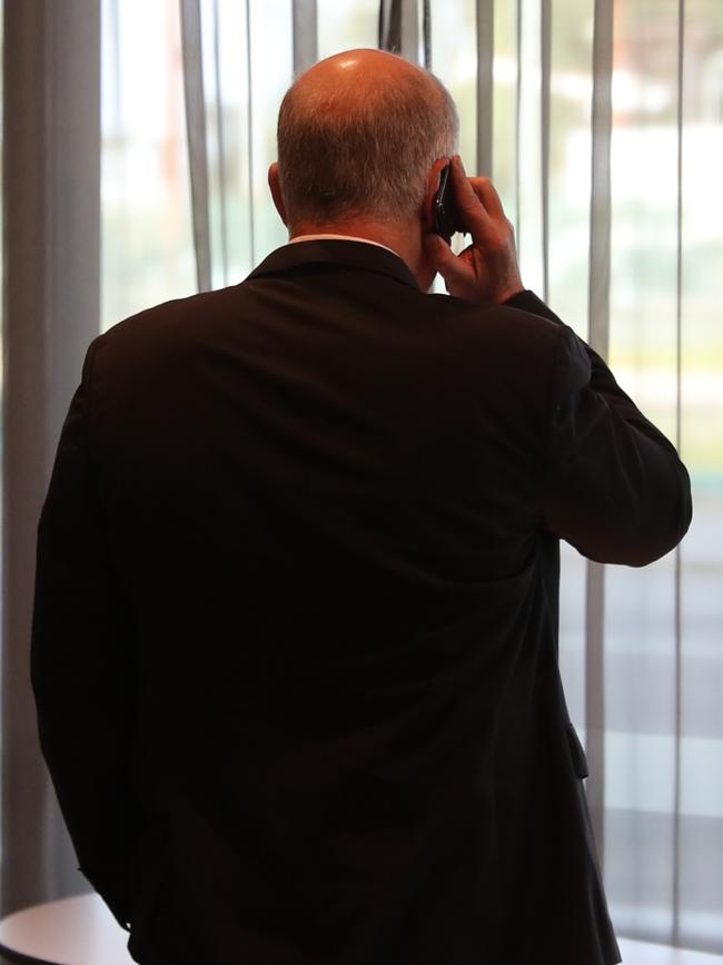 Prime Minister Scott Morrison talks on the phone.