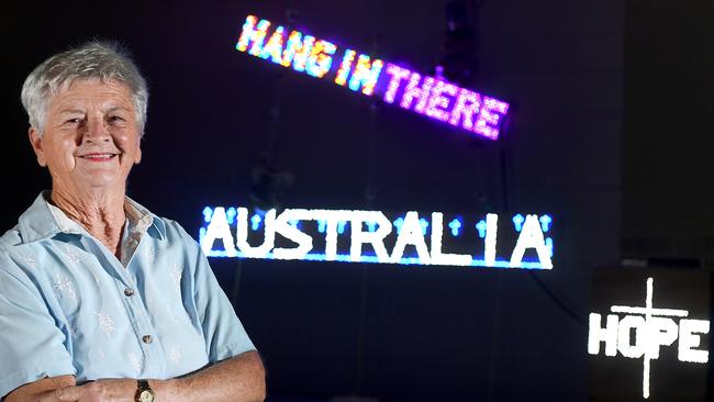 Carole Woodland with her ‘Hang in there Australia’ lights at her home in Bracken Ridge. Picture: AAP/John Gass