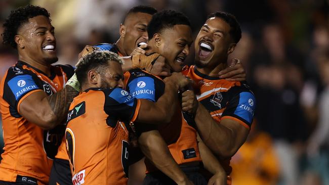 SYDNEY, AUSTRALIA - AUGUST 22: Latu Fainu of the Wests Tigers celebrates scoring a try during the round 25 NRL match between Wests Tigers and Manly Sea Eagles at Leichhardt Oval on August 22, 2024 in Sydney, Australia. (Photo by Jason McCawley/Getty Images)